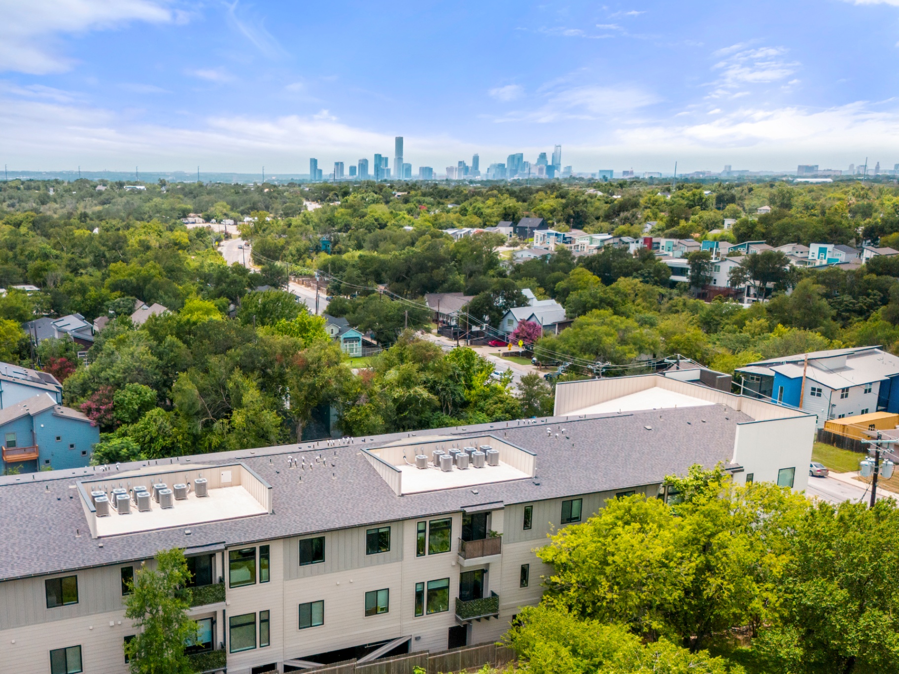Aerial view of East Grove community with downtown Austin skyline